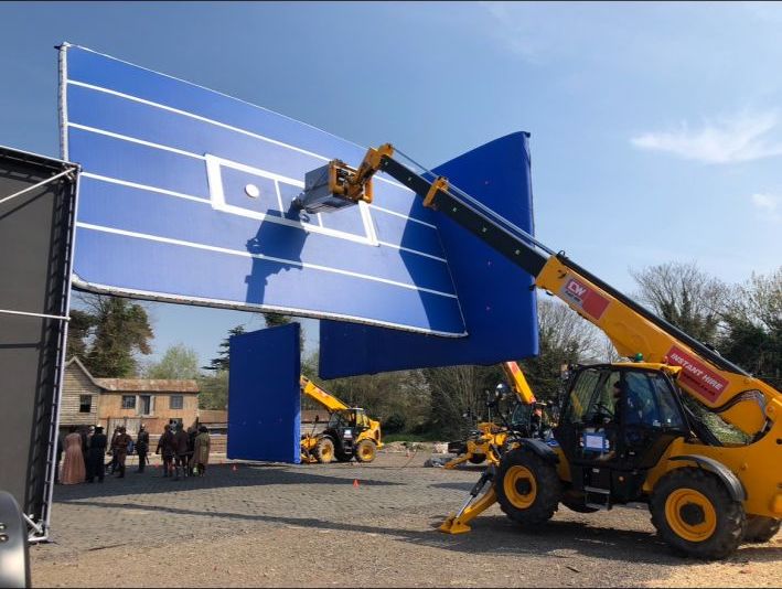 Blue AirPanel being lifted by a telehandler on location